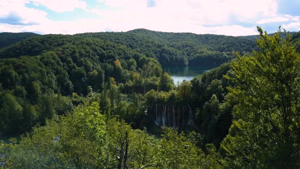 Drone shot of waterfall surrounded by lush area, Plitvice Lakes National Park, Croatia Stock