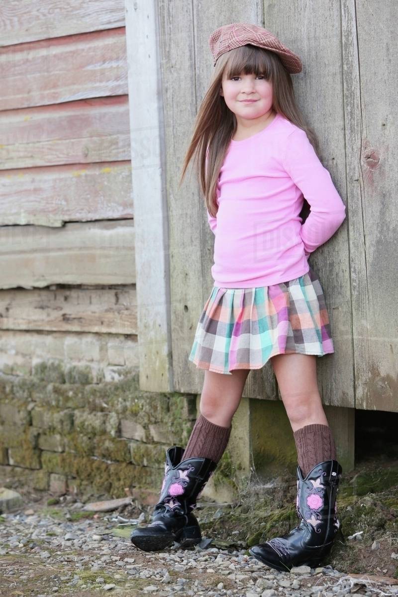 Young Girl Wearing A Hat And Cowboy Boots; Troutdale, Oregon, Usa
