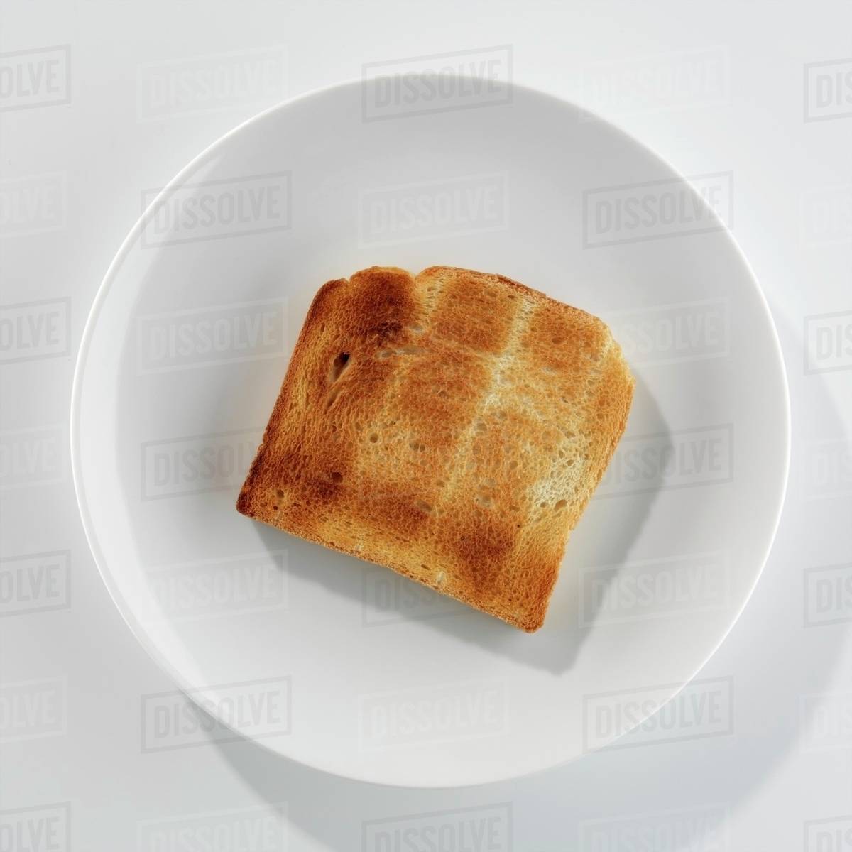 A slice of toast on a plate Stock Photo Dissolve
