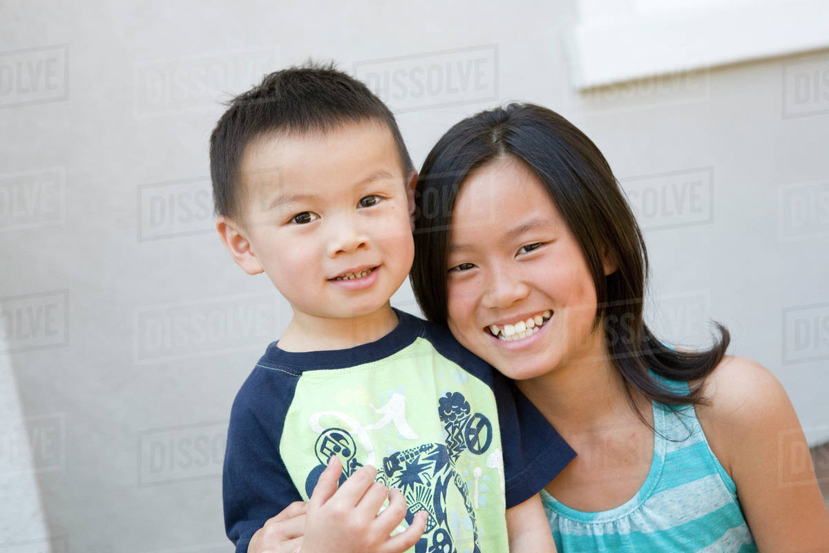 Chinese brother and sister hugging Stock Photo Dissolve