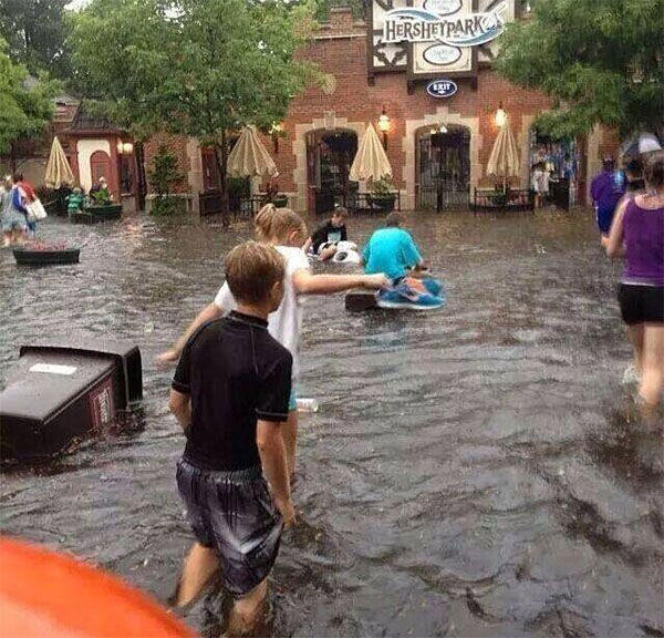 Flooding at Hersheypark children escaping flood by riding on floating trash cans and flower