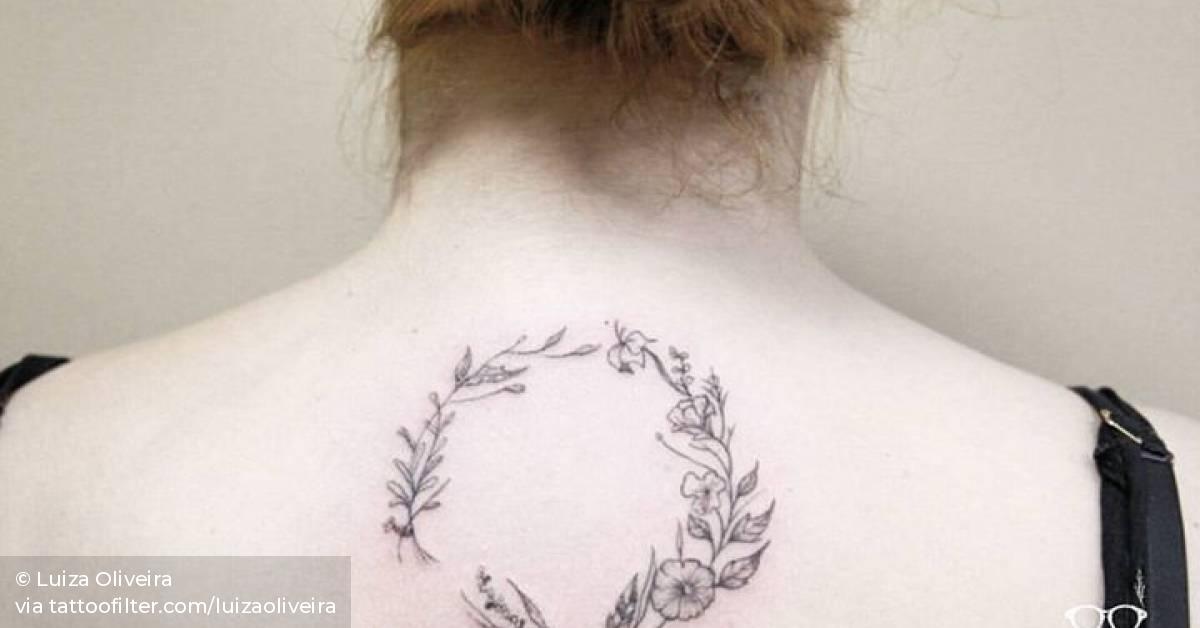 Floral wreath tattoo on the upper back.
