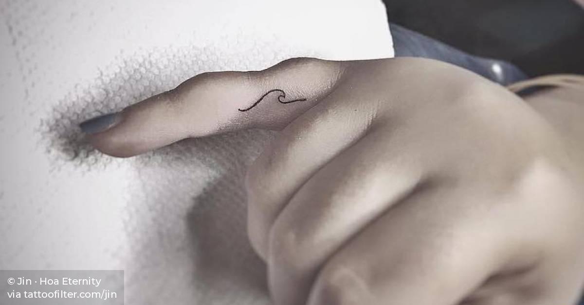 Tiny Wave Tattoo On The Pinky Finger.