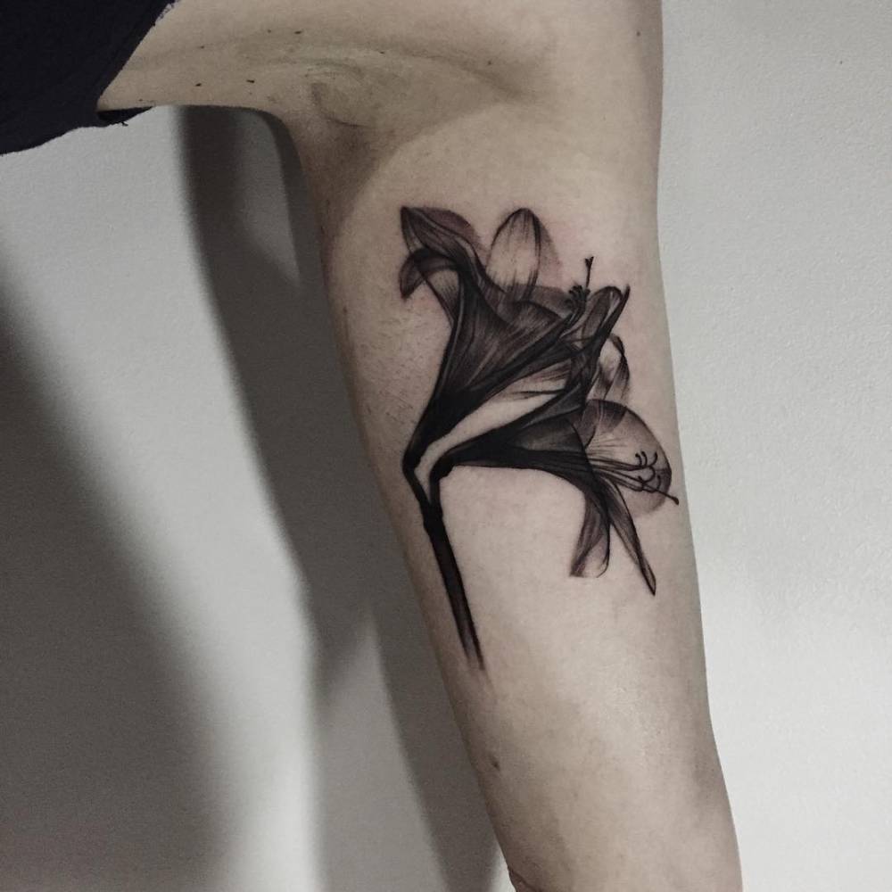 XRay lily tattoo on the left inner arm.