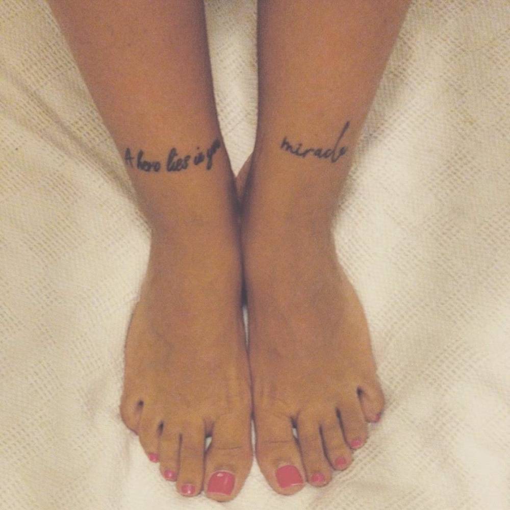 Shin tattoo saying "A hero lies in you" and "miracle",