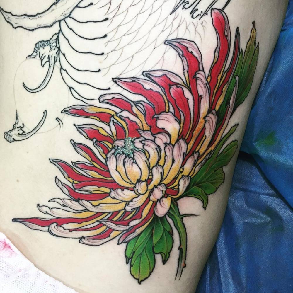 Japanese style chrysanthemum tattoo on the left side of