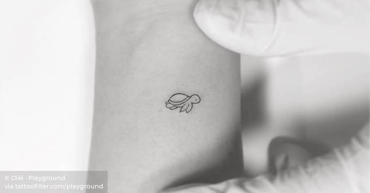 Minimalist turtle tattoo on the wrist.