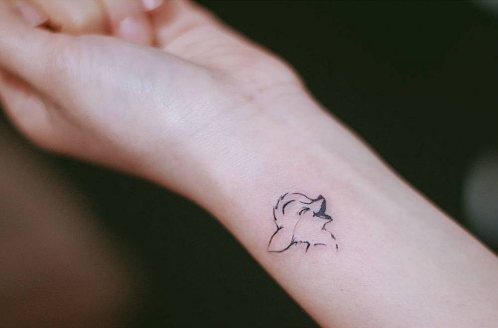 Small Bambi tattoo on the left inner wrist.