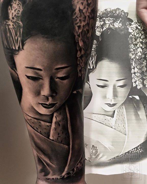 Black and grey geisha tattoo on the inner forearm.