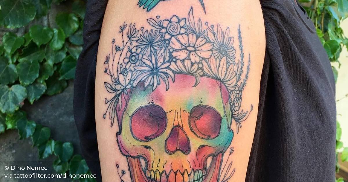 Sketchy skull and hummingbird tattoo on the right upper