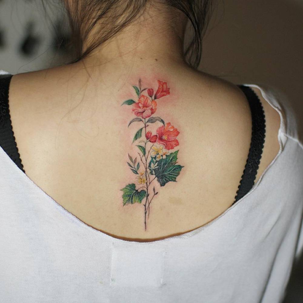 Flower bouquet tattoo on the upper back.