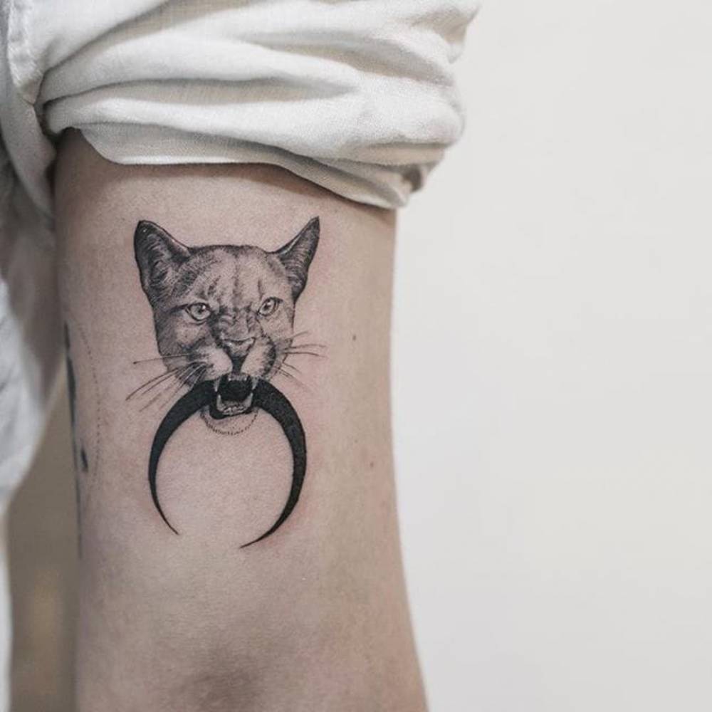 Puma Holding A Moon Tattoo On The Left Arm Bicep. 1000_x_1000_jpg