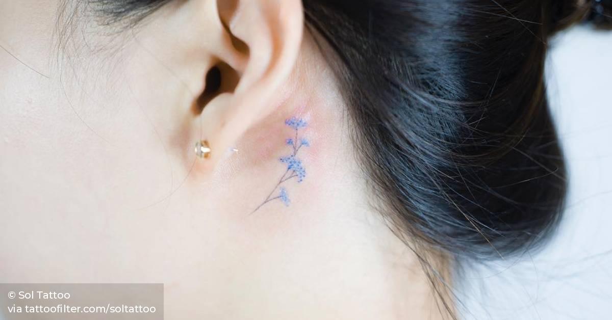 Tiny Blue Flower Tattoo Behind The Left Ear. 628_x_1200_jpg