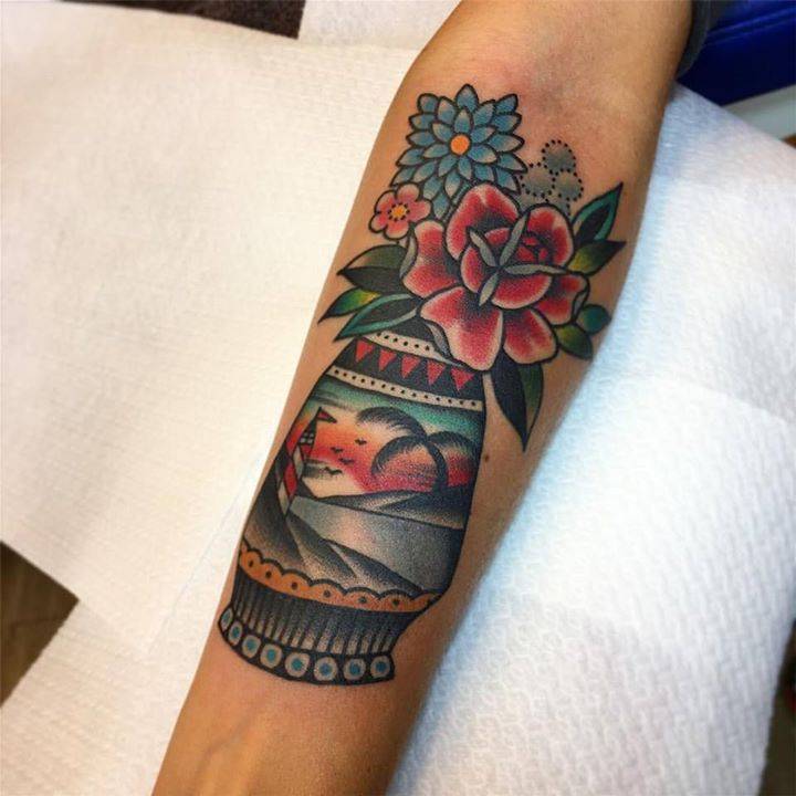 Vase of flowers tattoo on the inner forearm.