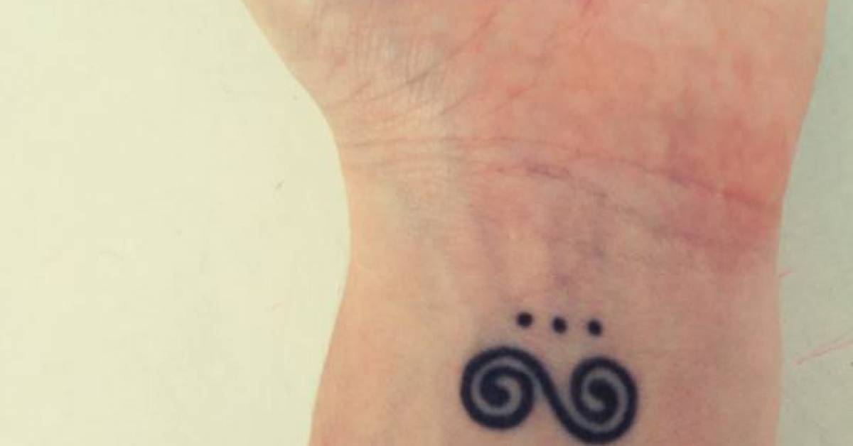 Tatuaje de una doble espiral y tres puntos en la