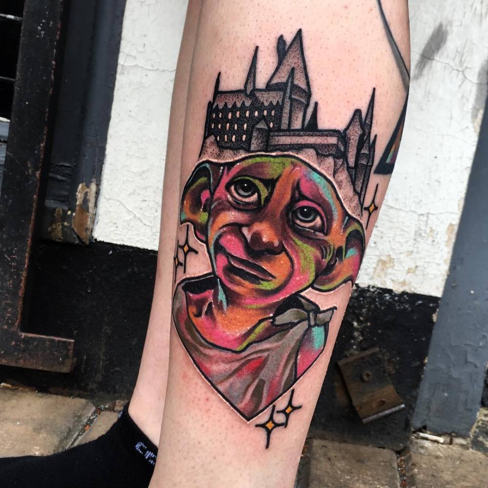 Dobby the elf tattoo on the leg.