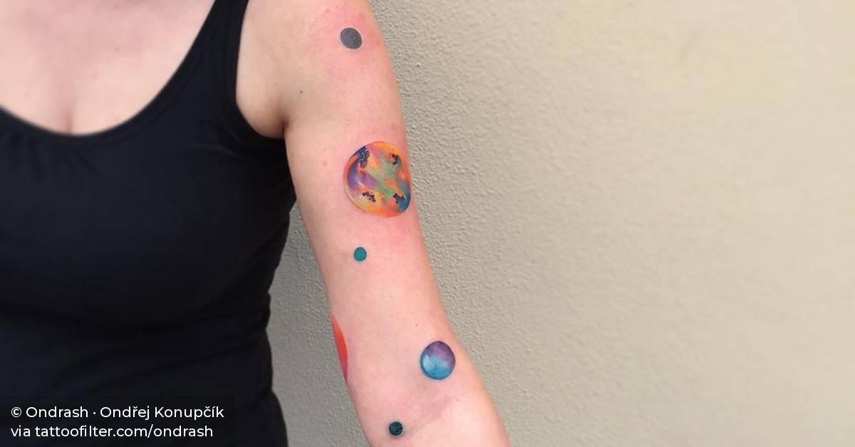 Abstract universe tattoo on the left arm.