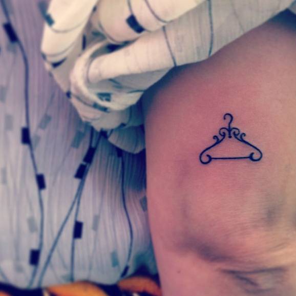 Hanger tattoo on the tricep.