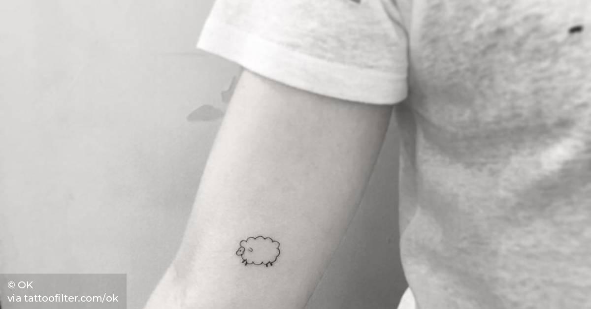 Minimalist sheep tattoo on the right inner arm.
