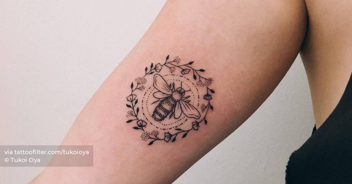 Bee + flowers tattoo on the inner arm