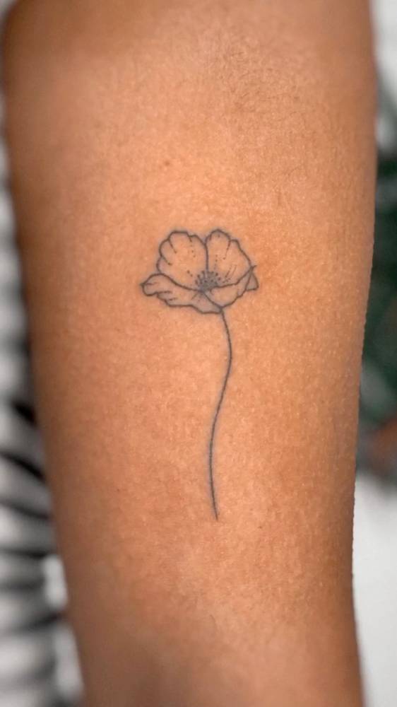 Hand poked poppy flower tattoo