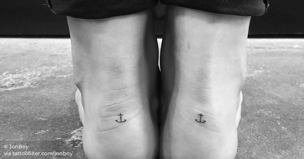 Minimalist matching anchor tattoos.
