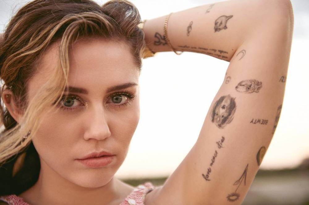 Love Never Dies" Miley Cyrus's Tattoo 665_x_1000_jpg