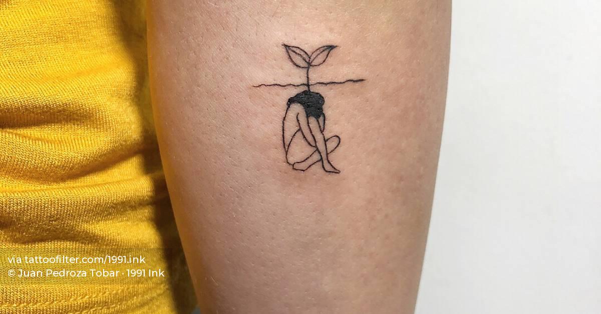 Woman sprouting tattoo on forearm