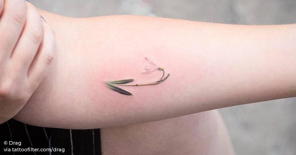 Snowdrop tattoo on the left inner forearm.