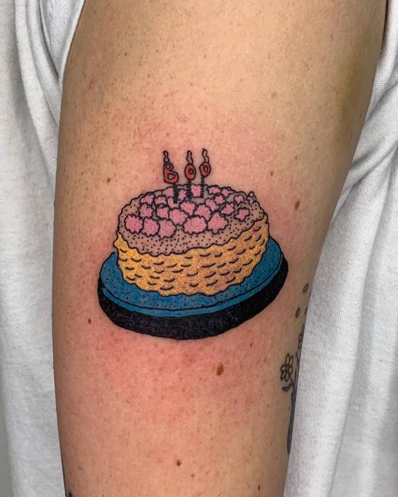 Cake tattoo on Ella Emhoff's upper arm