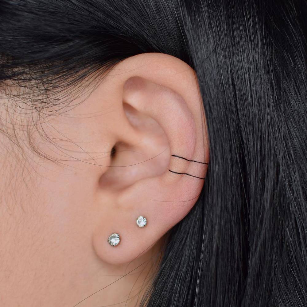 Minimalist lines tattoo on the ear