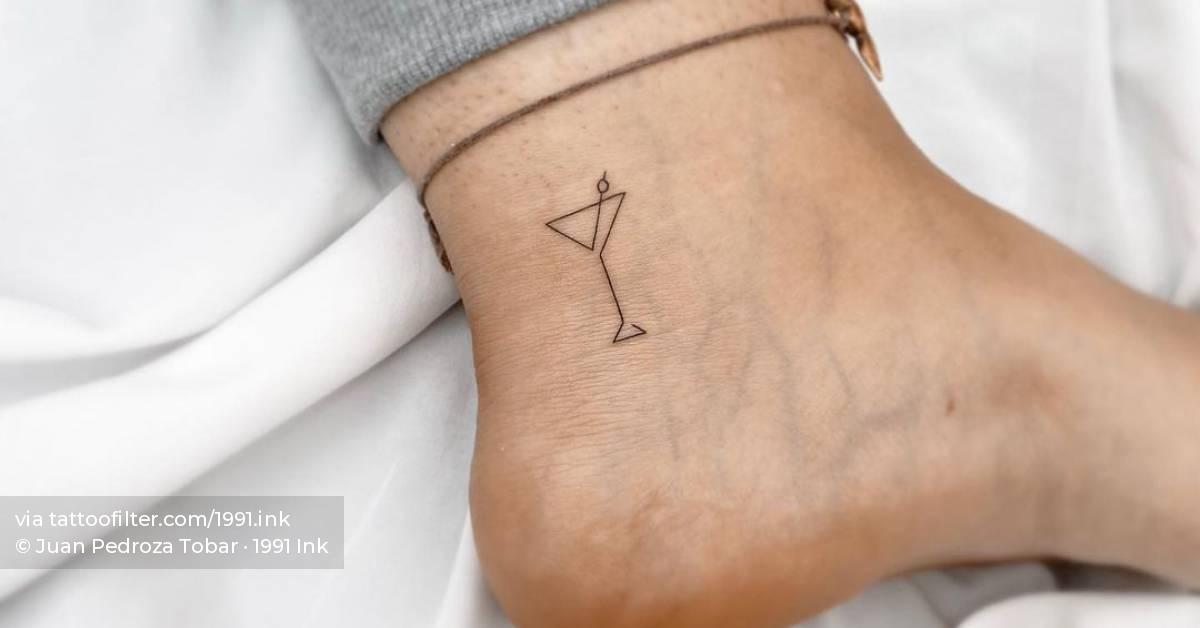 One line martini cocktail tattoo on the ankle