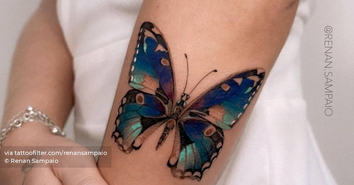 Blue butterfly tattoo on the forearm.