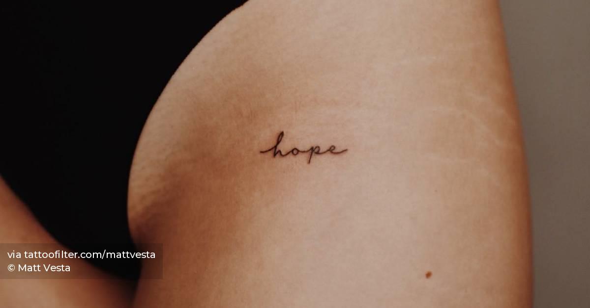 "Hope" lettering tattoo on the pelvis.