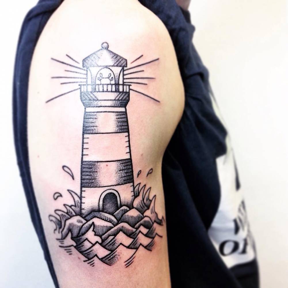 Lighthouse tattoo on the upper arm.