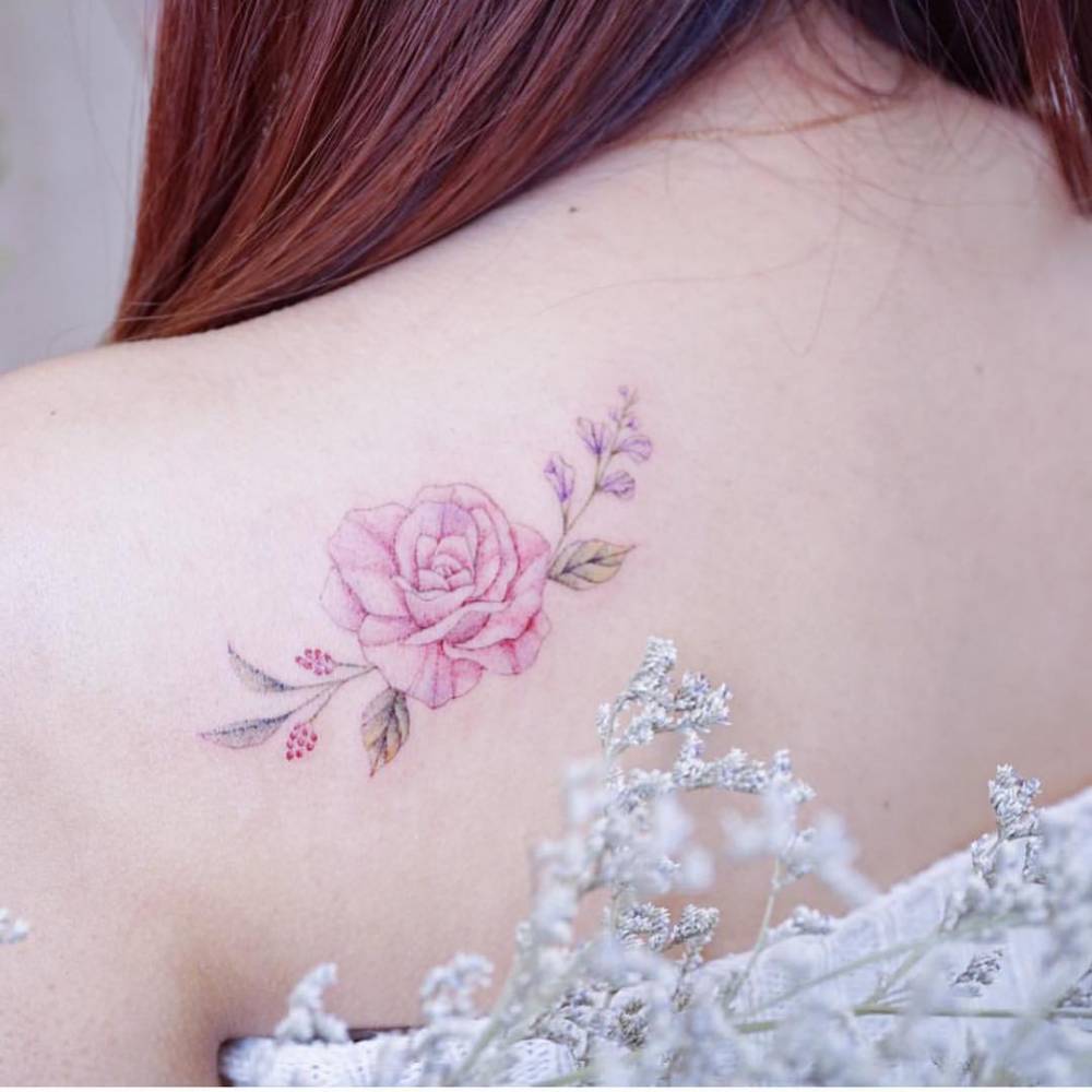 Watercolor pink rose tattoo on the shoulder blade.