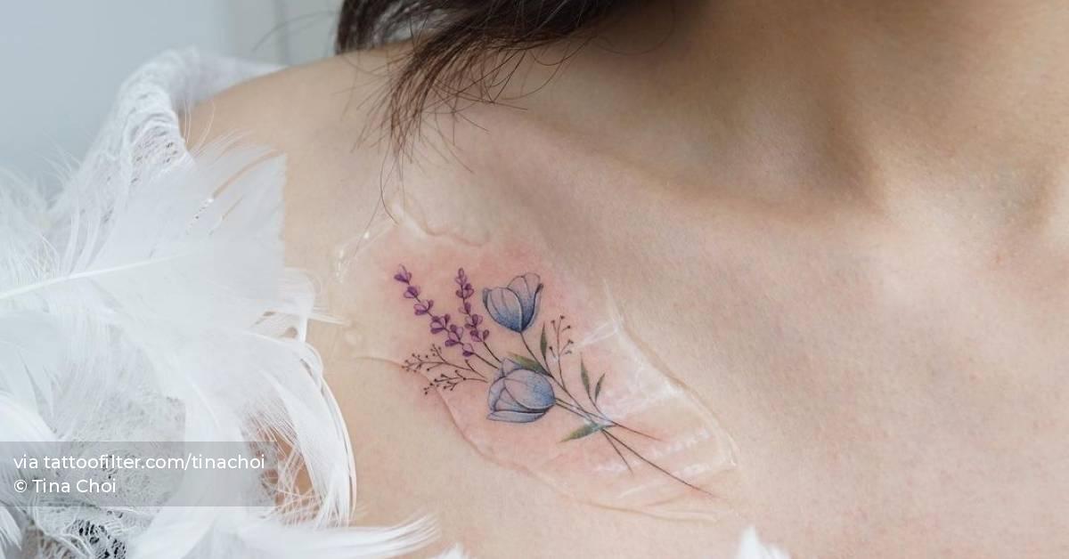 Watercolor flowers tattoo on the collarbone.