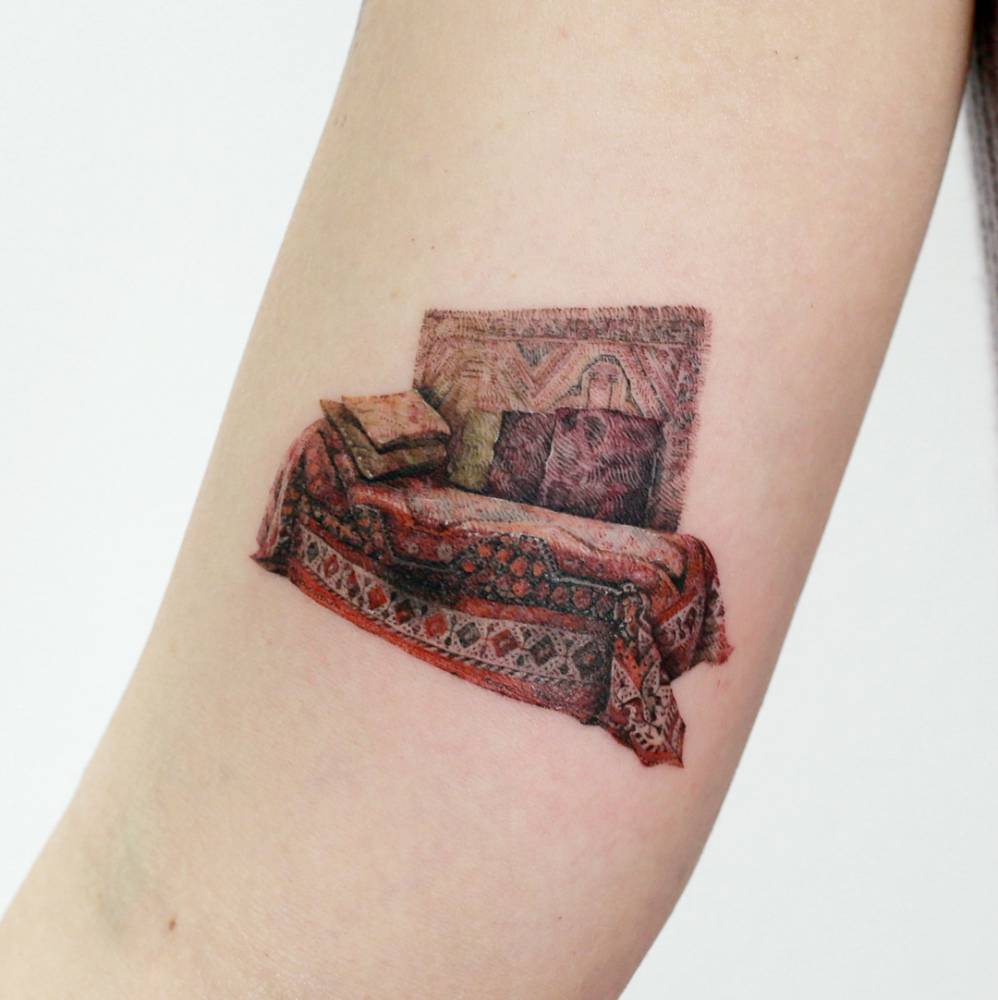 Freud's couch tattoo on the inner arm.