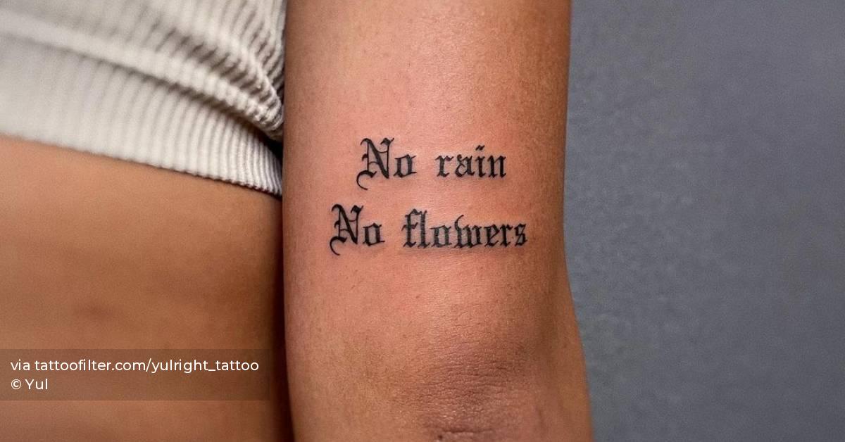 "No rain, no flowers" lettering tattoo on the tricep.