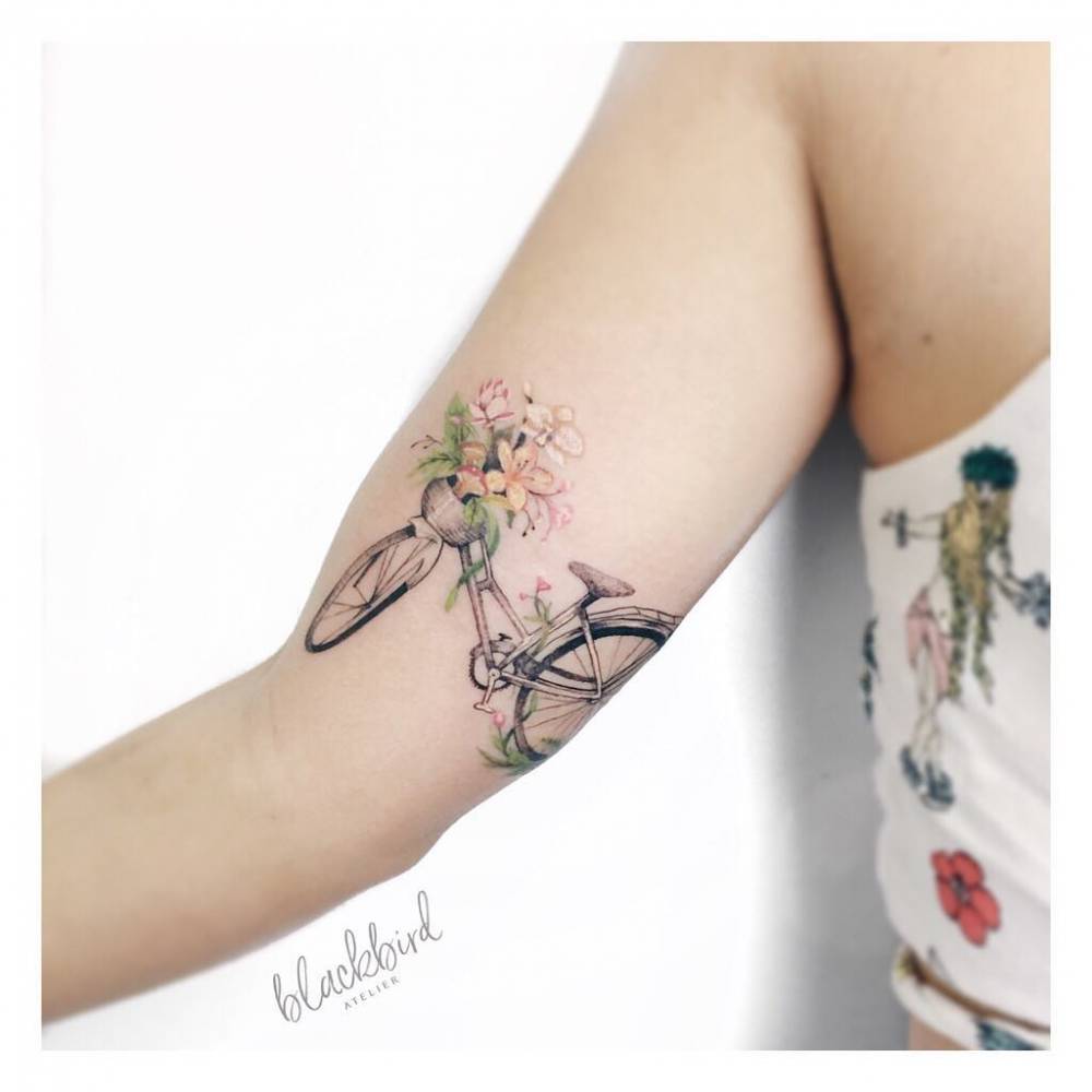 Bike tattoo on the right inner arm.