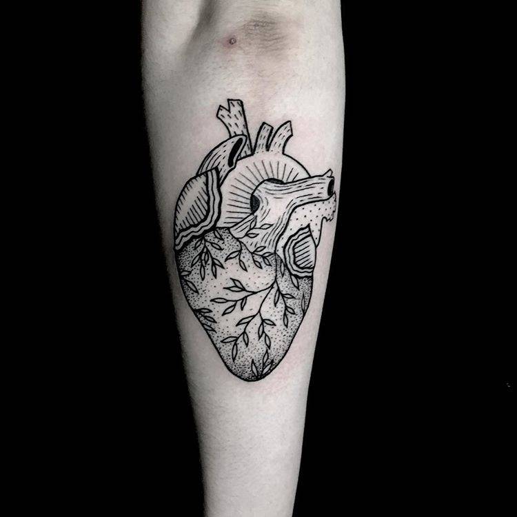 Anatomical heart tattoo on the forearm.