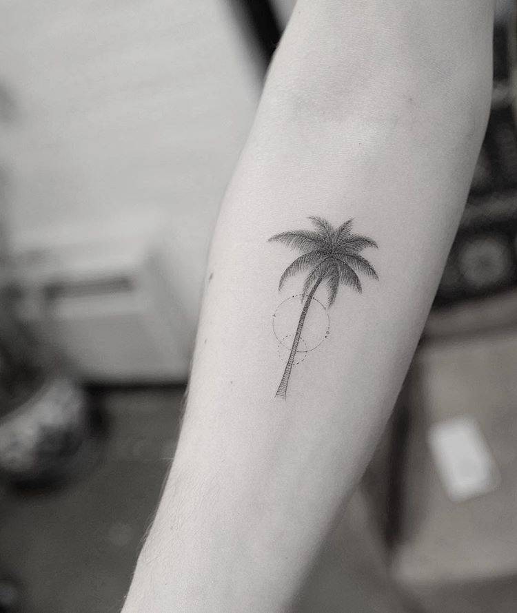 Single needle palm tree tattoo on the right inner