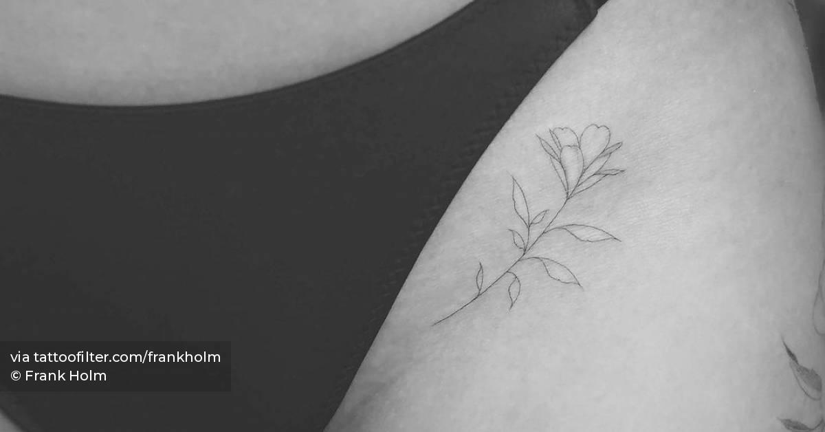 Fine line flower tattoo on the pelvis.