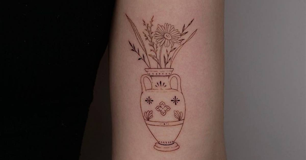 Tattoo of flowers in a vase, done in fine line, located