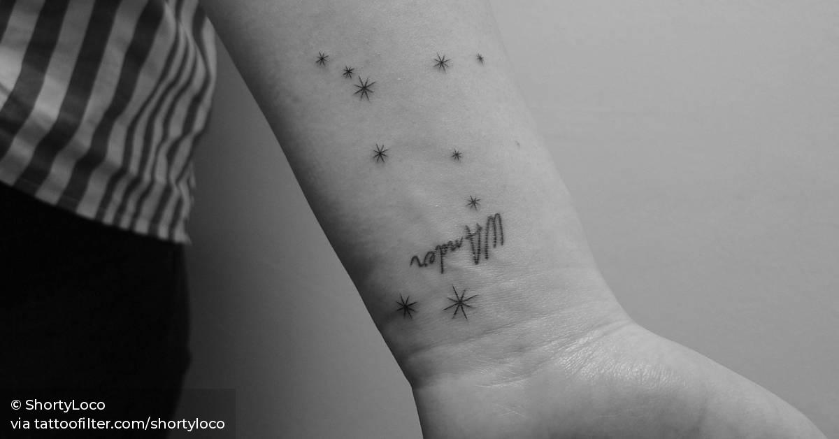 Gemini constellation tattoo on the inner wrist.