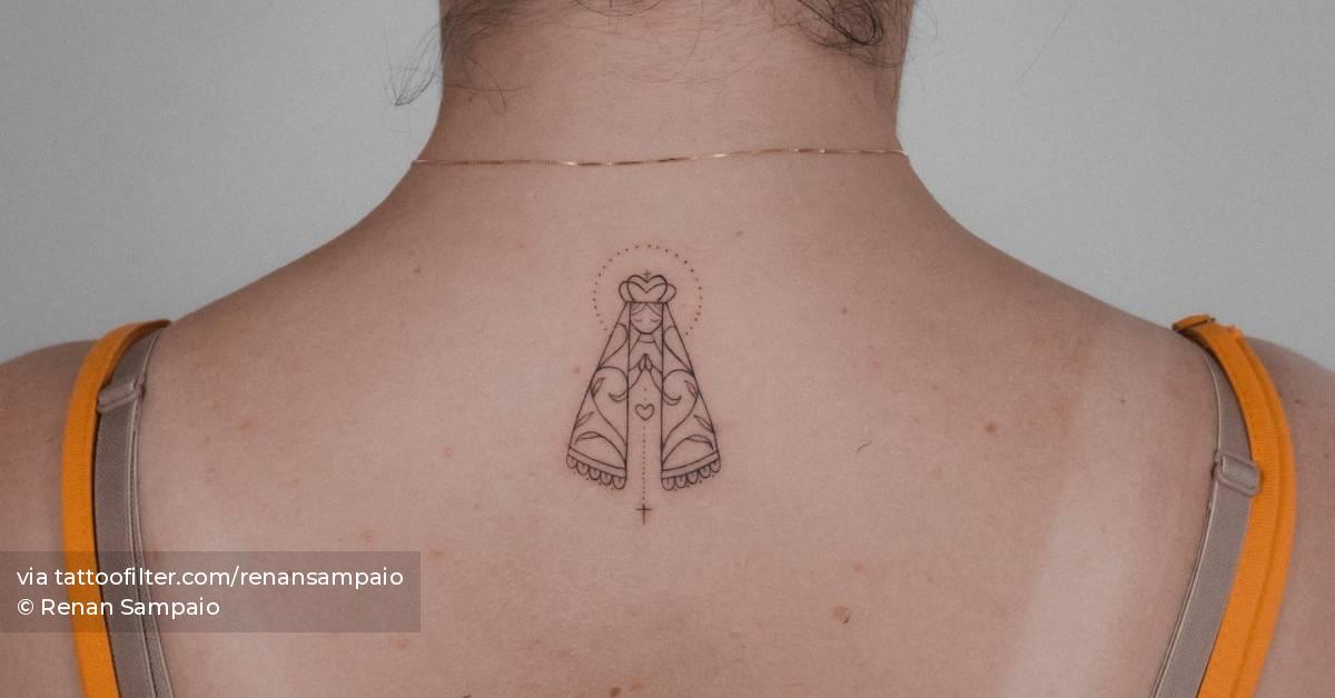 Virgin Mary tattoo located on the upper back.
