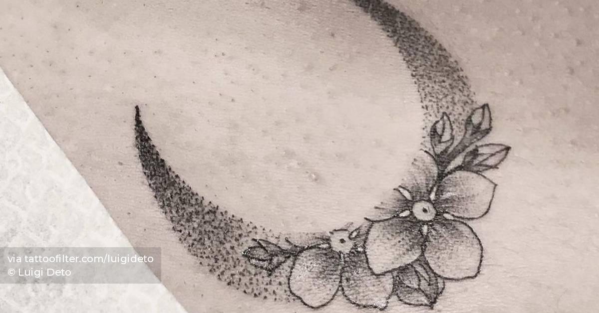 Flower moon tattoo on pelvis