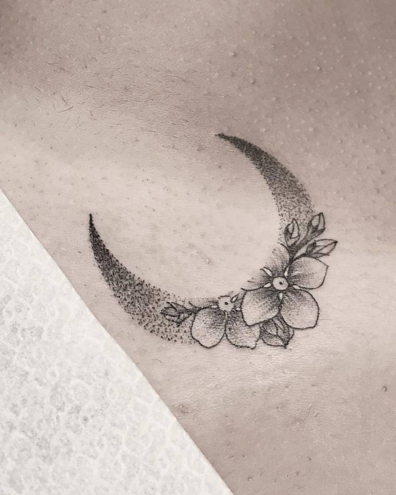Flower moon tattoo on pelvis