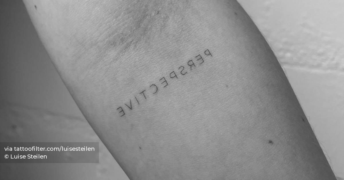 Tattoo of the word "perspective" in mirror writing.