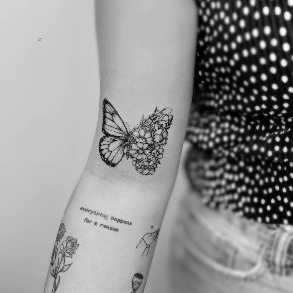 Half butterfly half flowers tattoo done on the bicep.